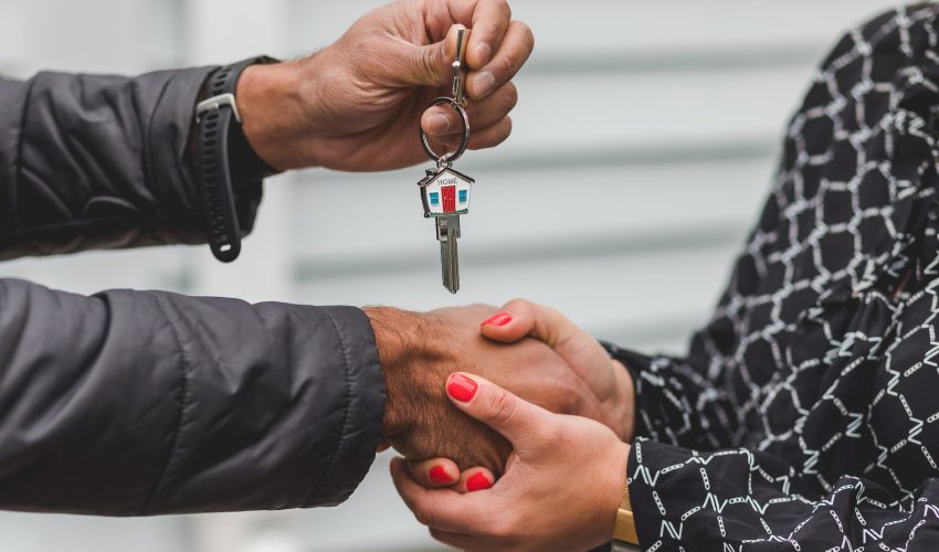 person holding silver key